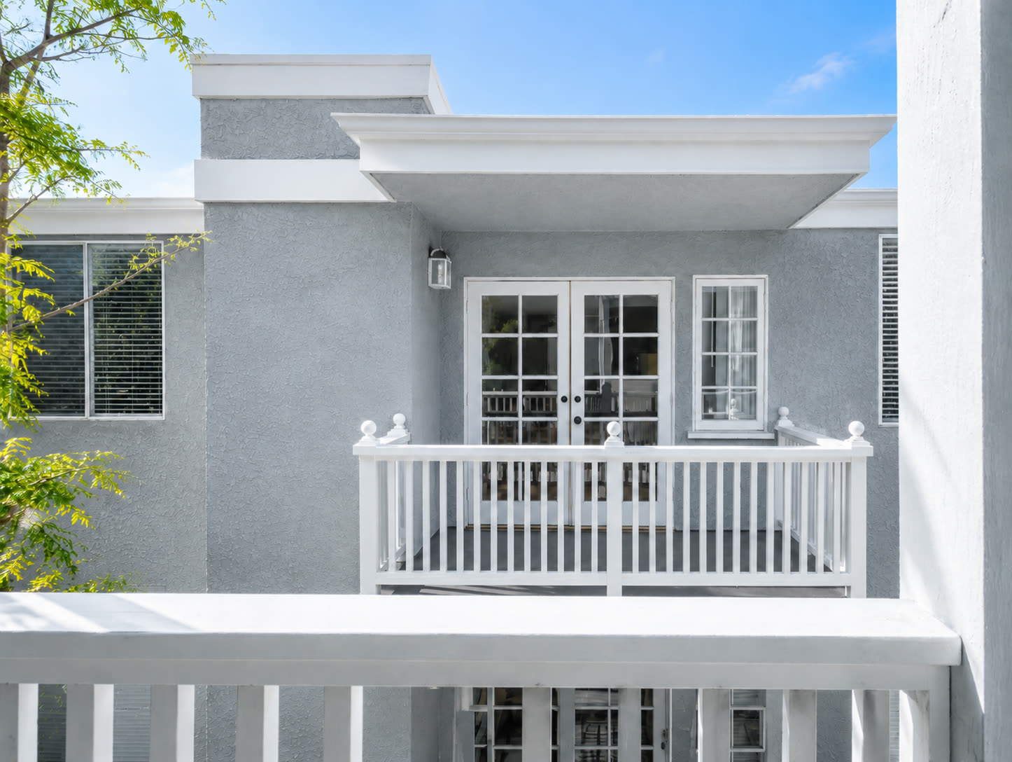 Private balcony with white railing and French doors
