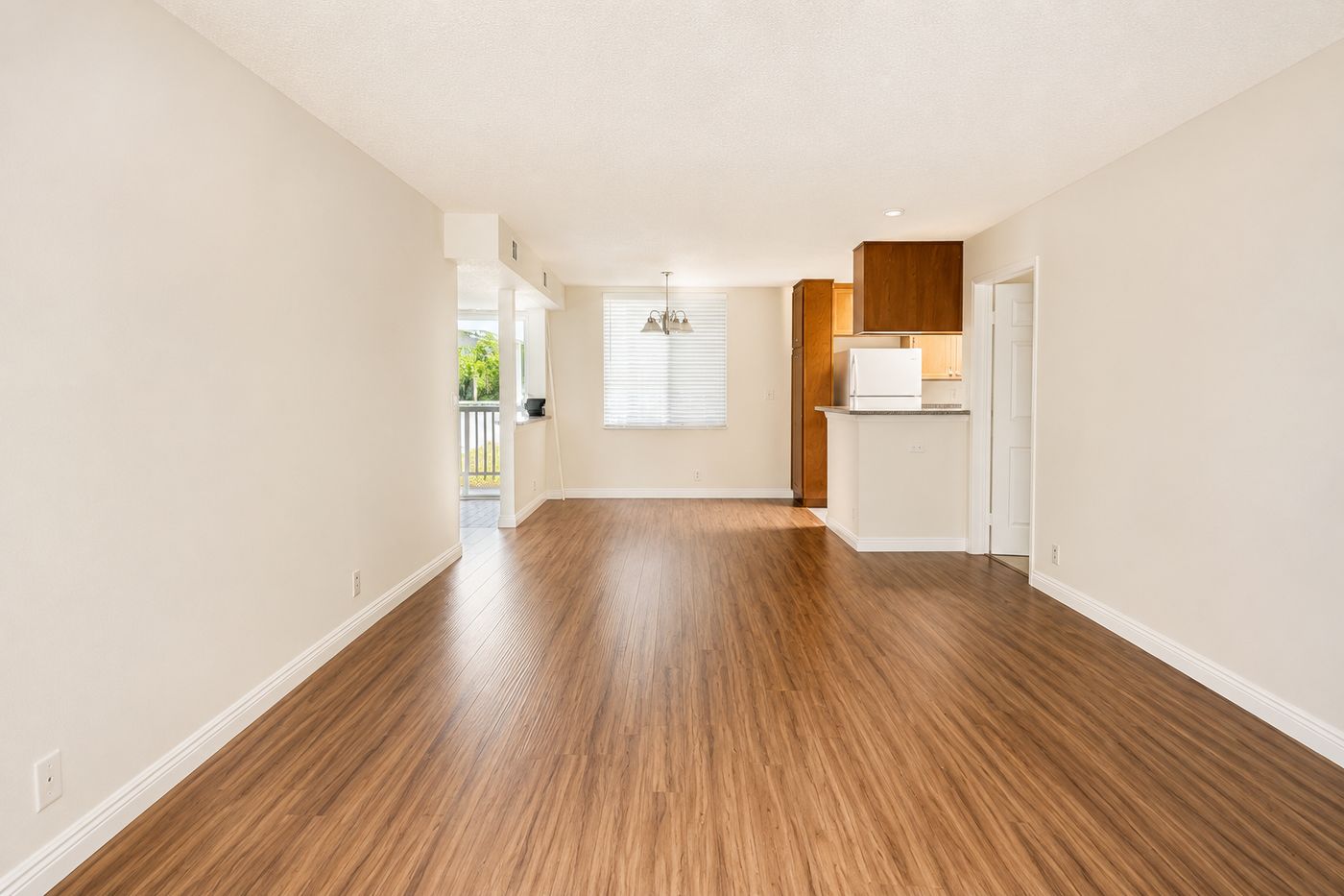 Bright open living and dining room with wood-style floors