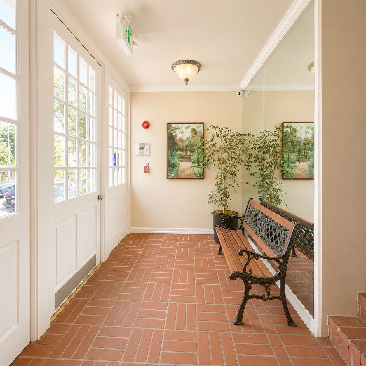 Entry lobby with brick tile floor and garden bench