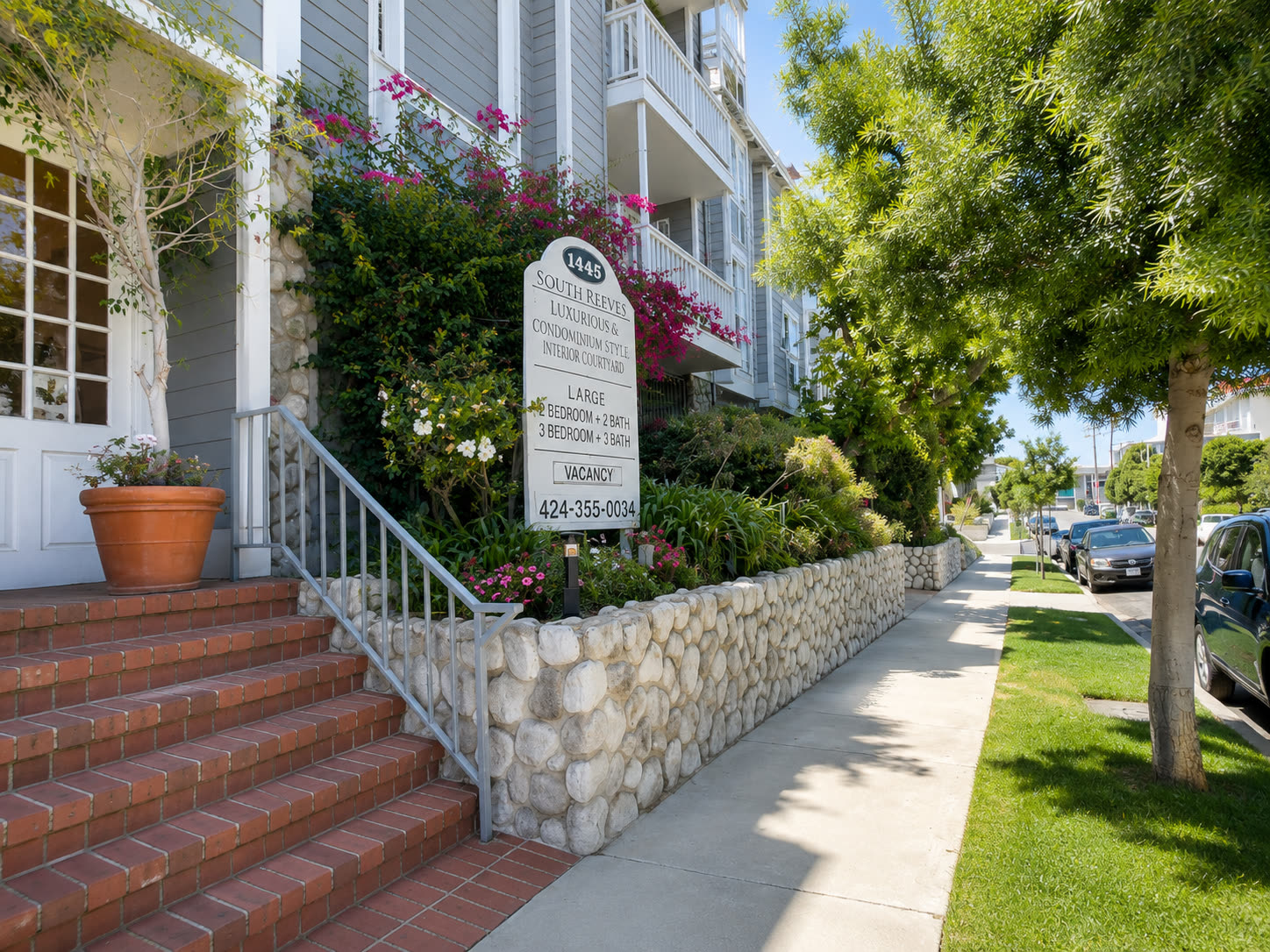 Tree-lined South Reeves Street sidewalk outside the residence